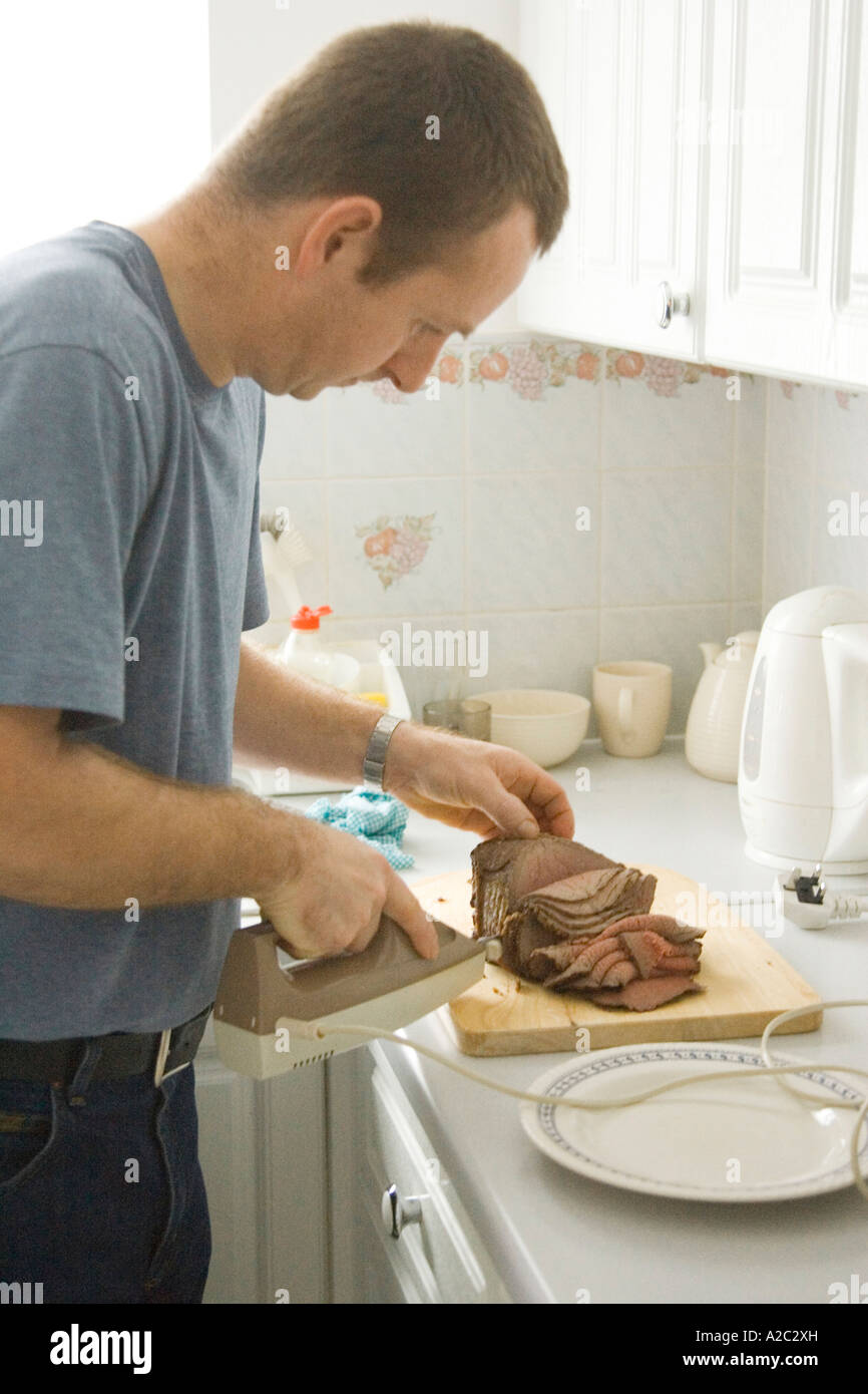 A man carving a joint of beef meat Stock Photo Alamy