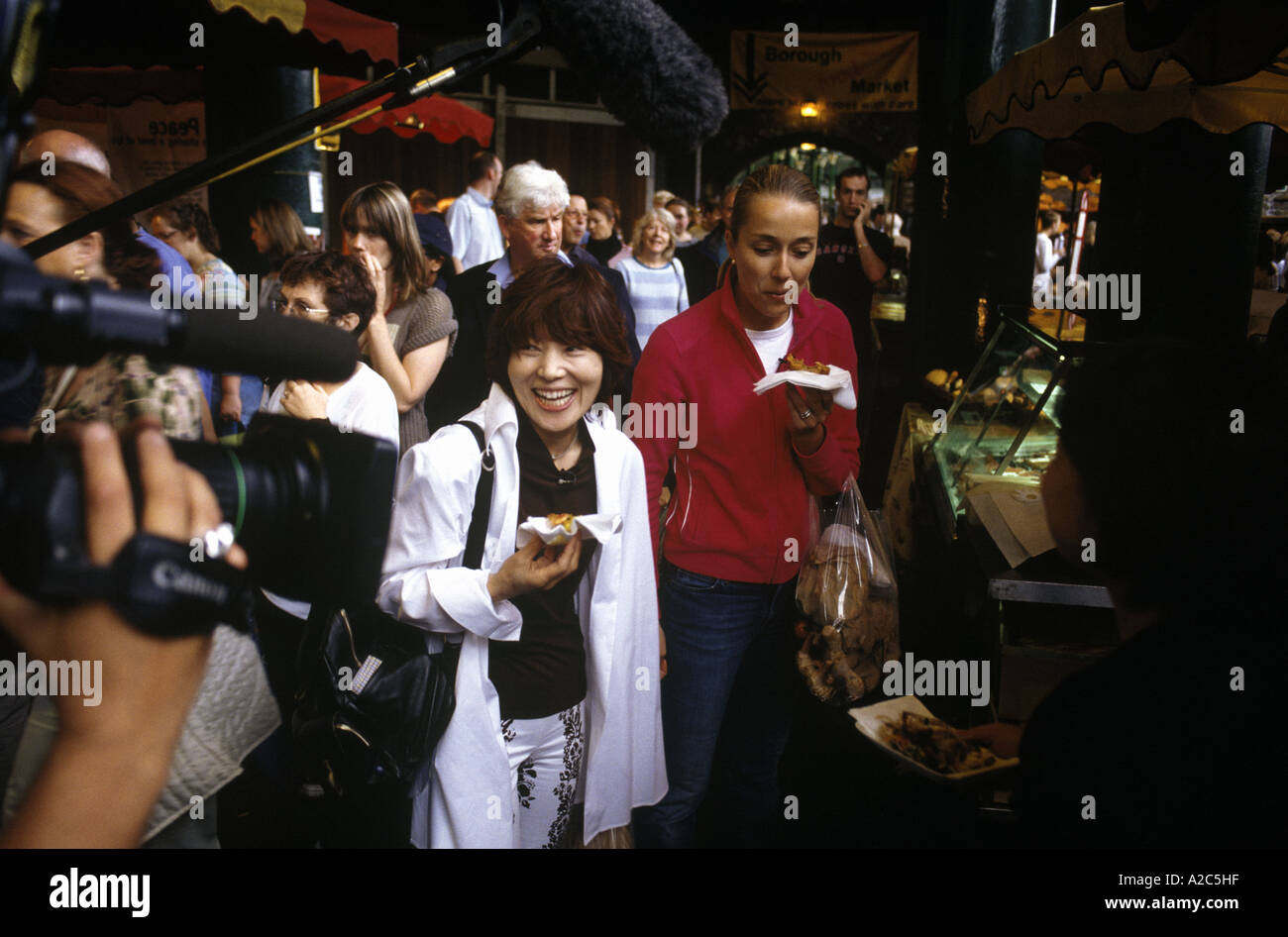 Harumi Kurihara, celebrity chef and Japanese television film  crew at Borough Market London 2005 Stock Photo