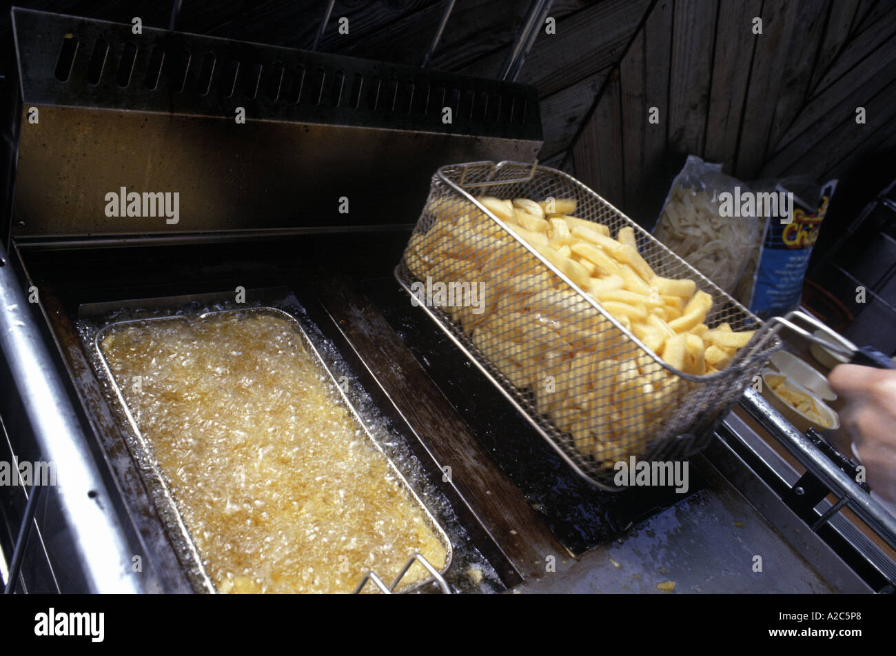 chips in a deep fat fryer Stock Photo Alamy
