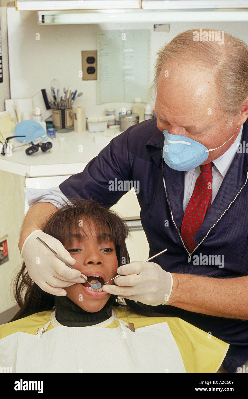 Dentist examining patient's teeth Stock Photo