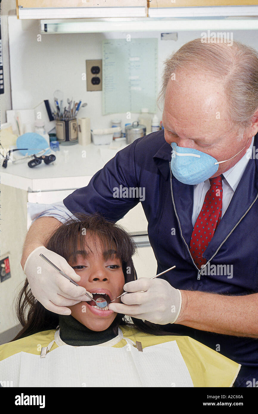 Dentist examining patient's teeth Stock Photo