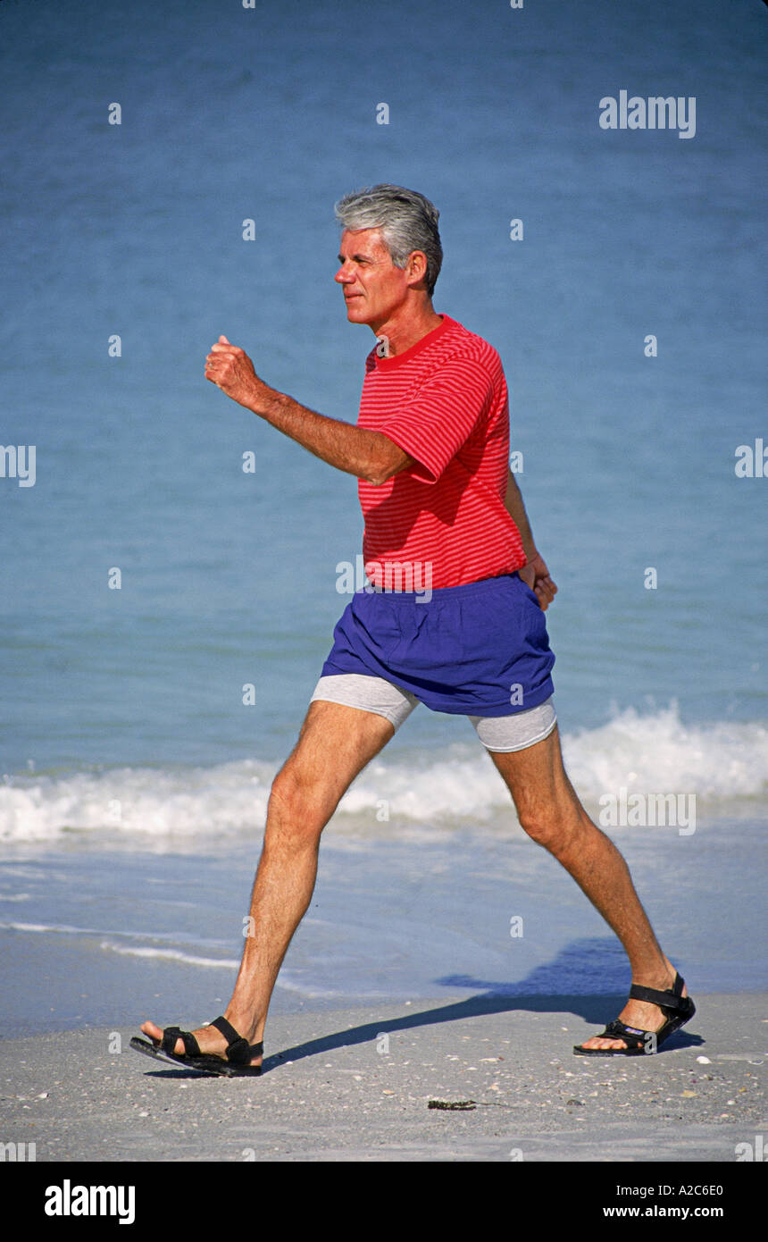 Vertical shot of senior male walking fast on beach  POV  MR  © Myrleen Pearson Stock Photo