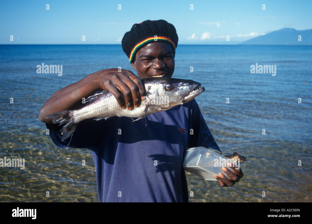 a native young man is presenting a big fish he has just caught in Lake  Malawi Stock Photo - Alamy