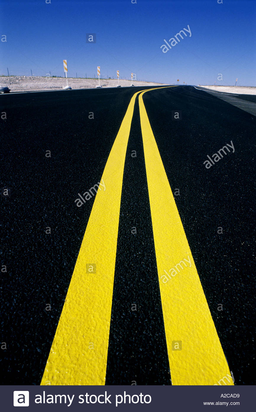 Yellow line on road stripes on fresh paved highway New Mexico USA Stock