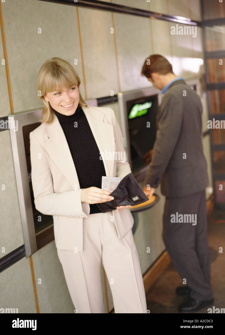 Withdrawing cash from dispenser Stock Photo