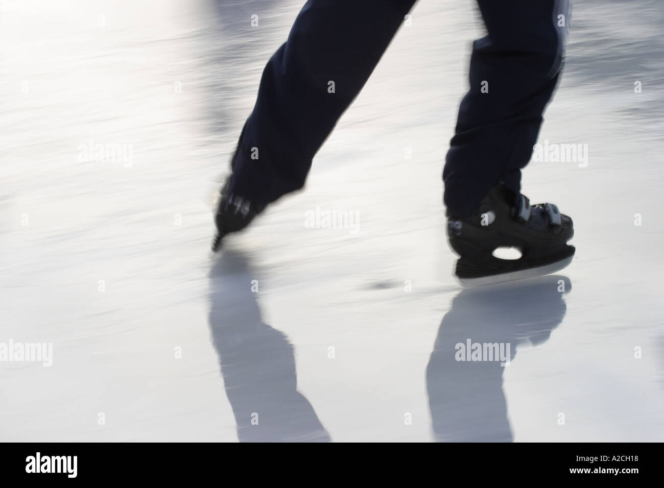 Feet and blades of ice skater skating on ice Stock Photo Alamy