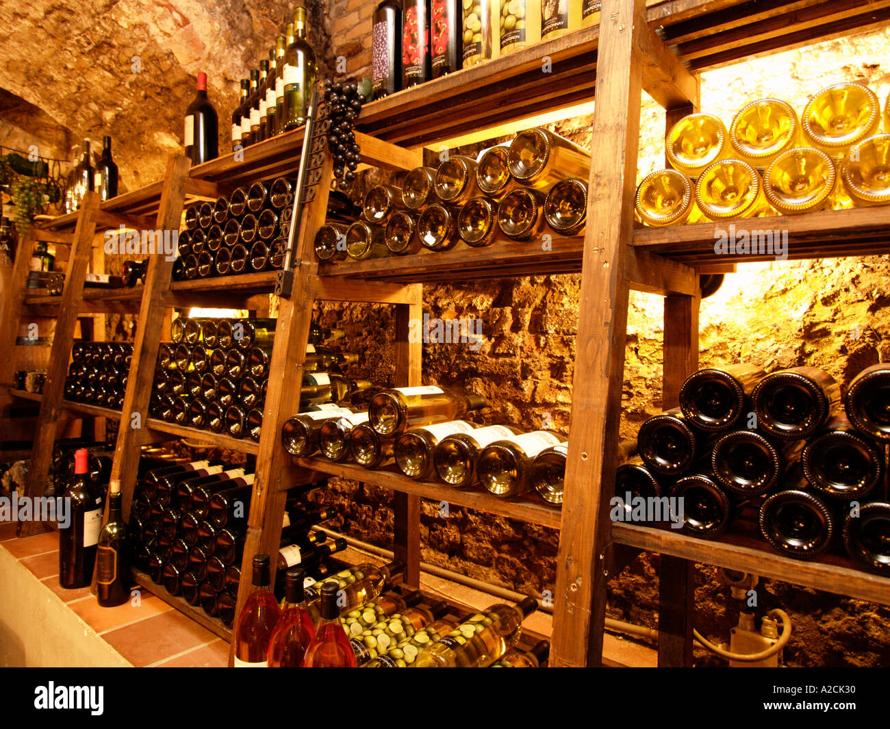 14th century brick cellar with wooden racks in it with many wine bottles old winecellar in warm light Stock Photo Alamy
