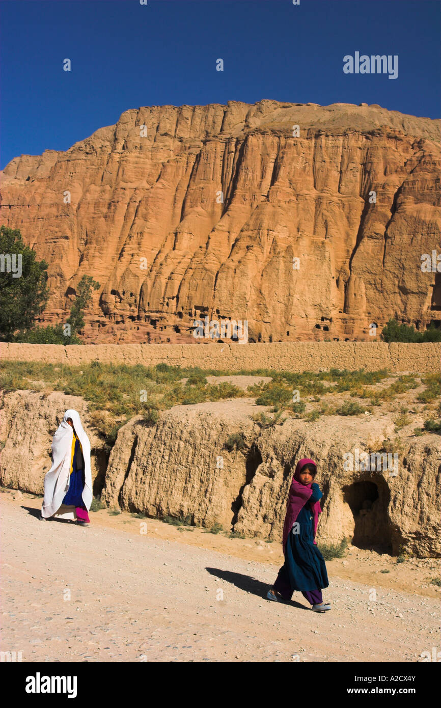 AFGHANISTAN Bamiyan Province Bamiyan People walking past remains of