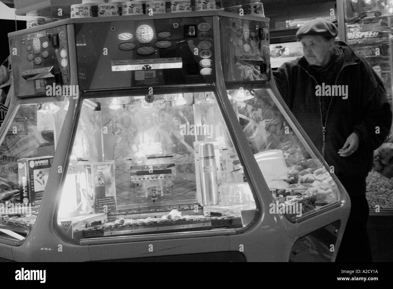 black and white image off an arcade with people playing the machines Stock Photo