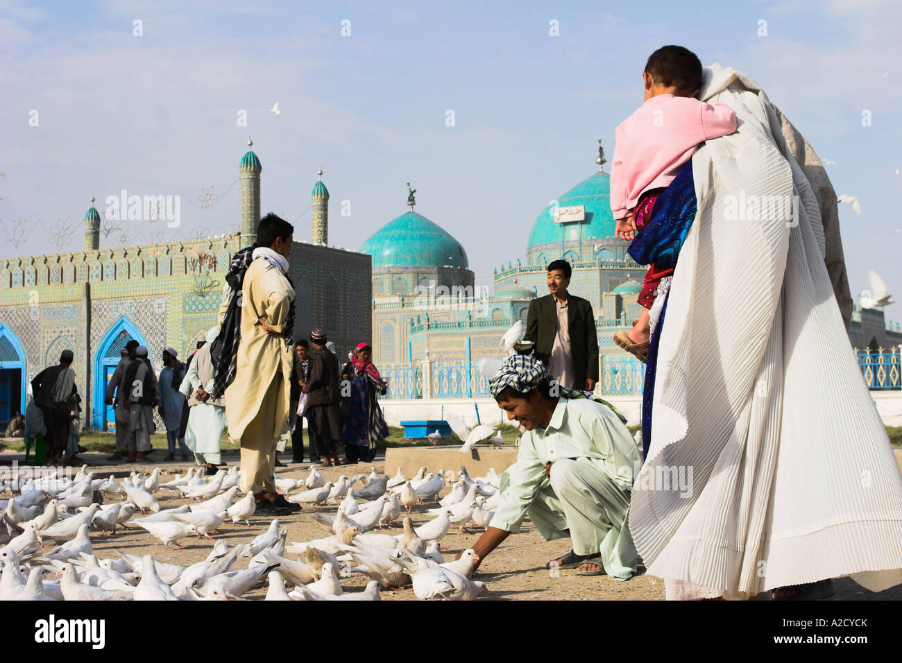 AFGHANISTAN Mazar I Sharif Family feeding famous white pigeons at ...