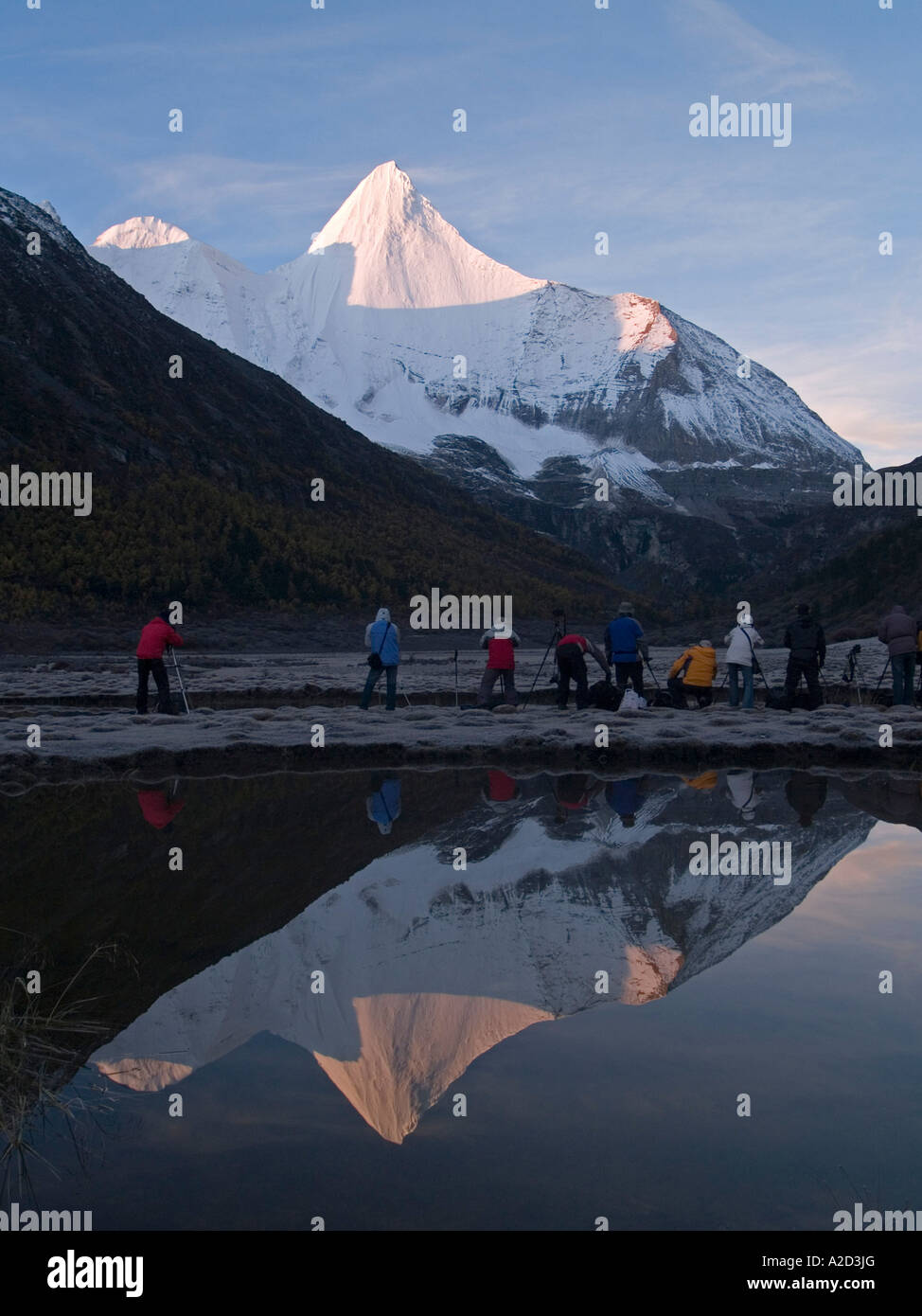 photographers at dawn capturing the holy Tibetan peak of Yanmaiyang ...