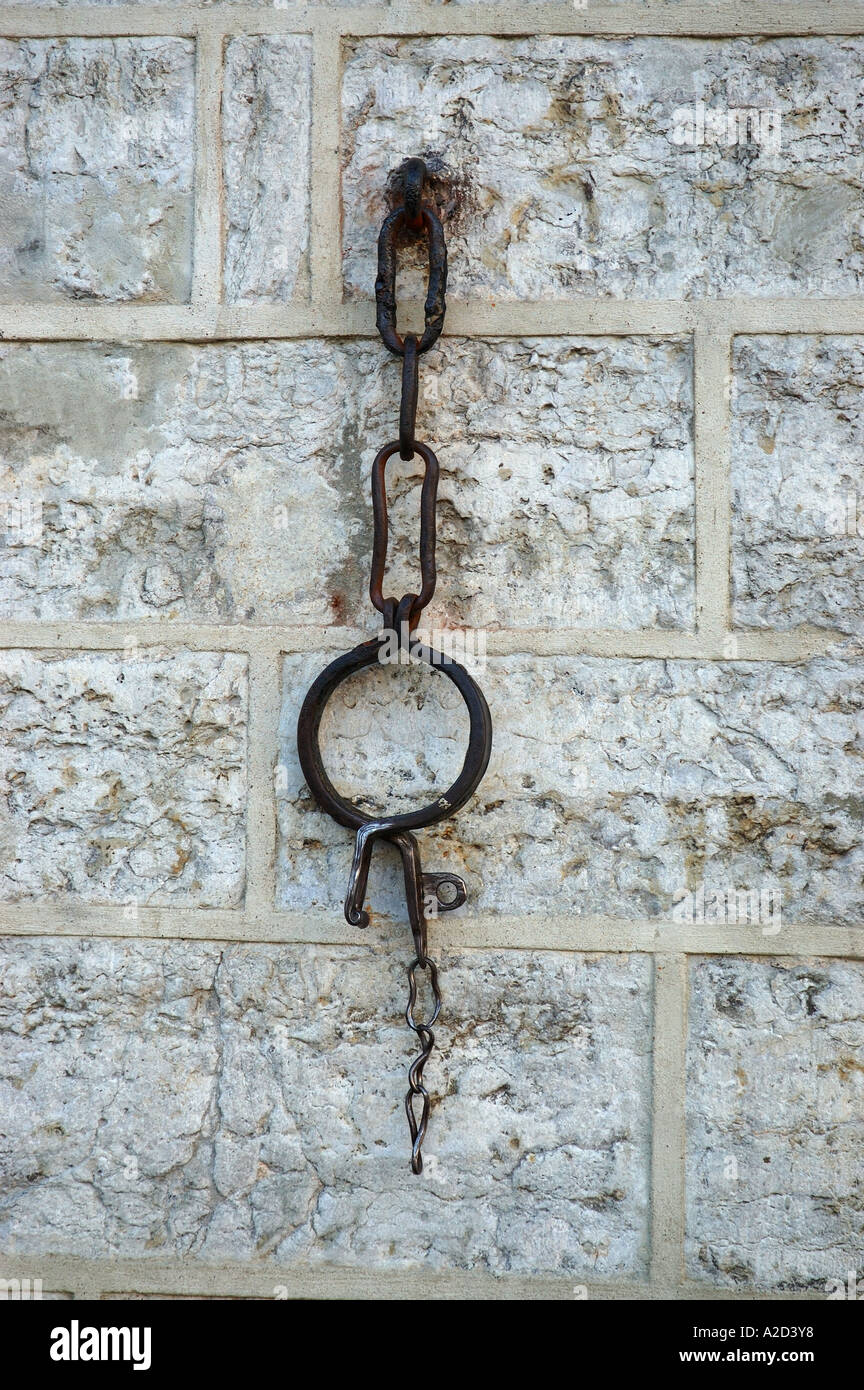 Iron shackle hanging from a stone wall Stock Photo 5991415 Alamy