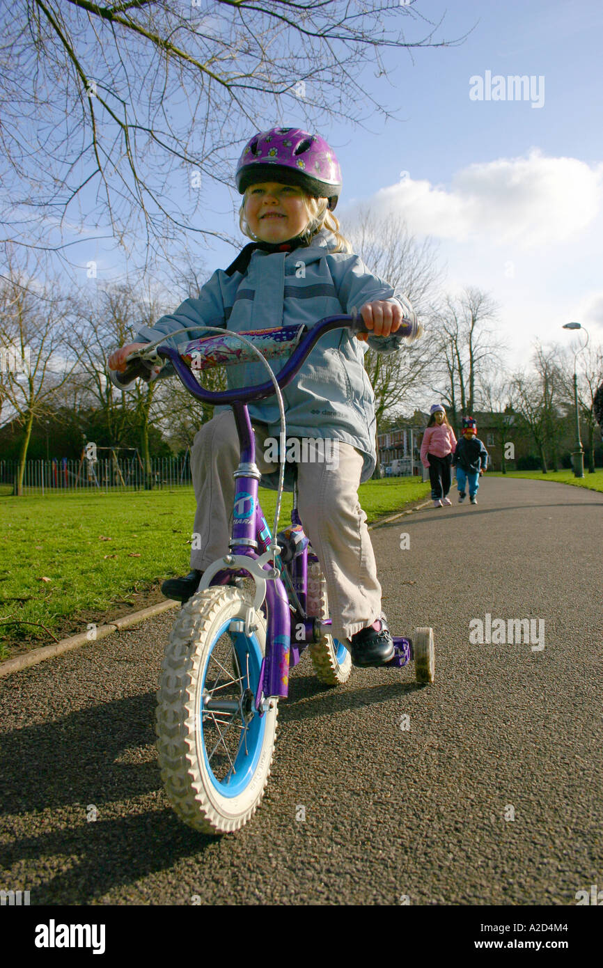 young girl on bicycle in park Stock Photo