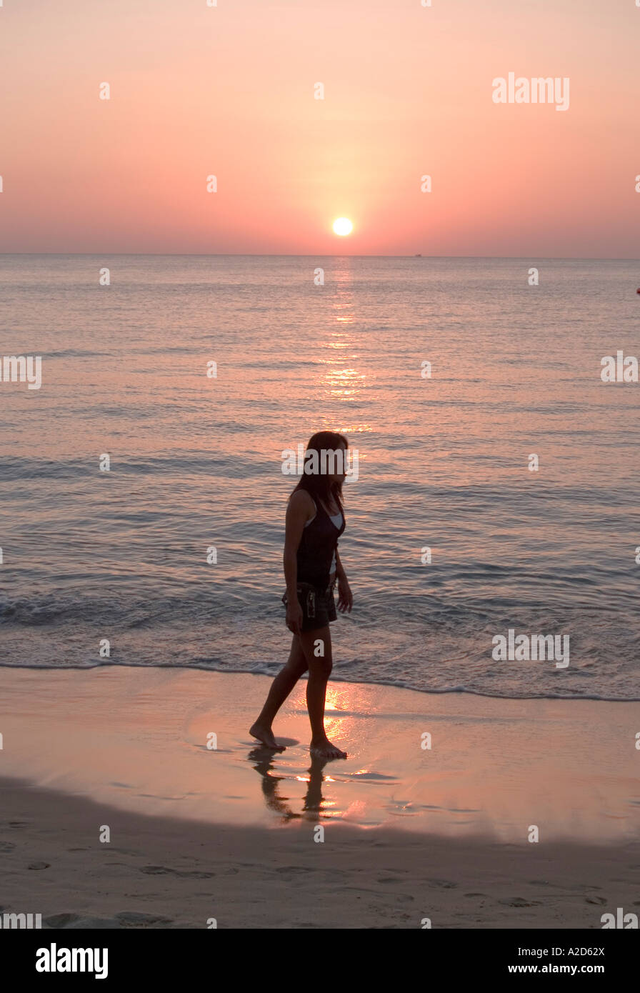 woman walking along the beach at sunset Phuket Thailand Stock Photo - Alamy