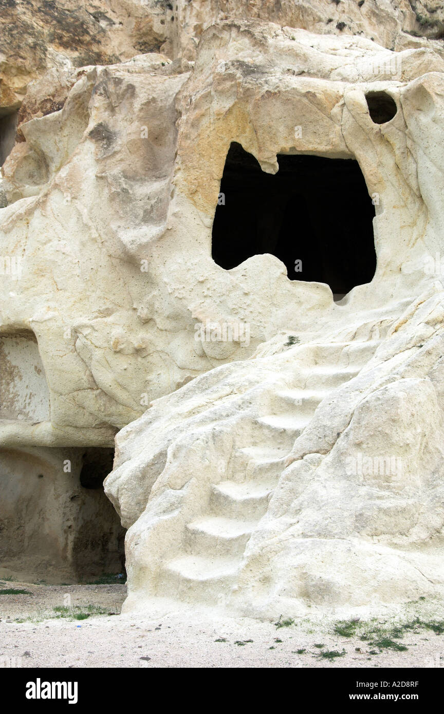 The volcanic landscape of cone shaped rock, carved caves and dwellings ...