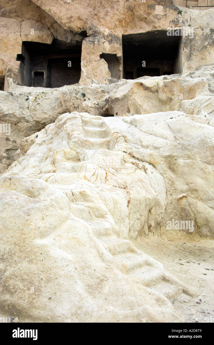 The volcanic landscape of cone shaped rock, carved caves and dwellings ...