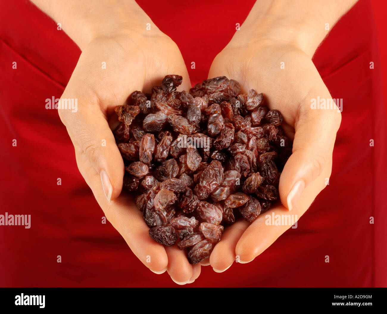 WOMAN HOLDING RAISINS Stock Photo - Alamy