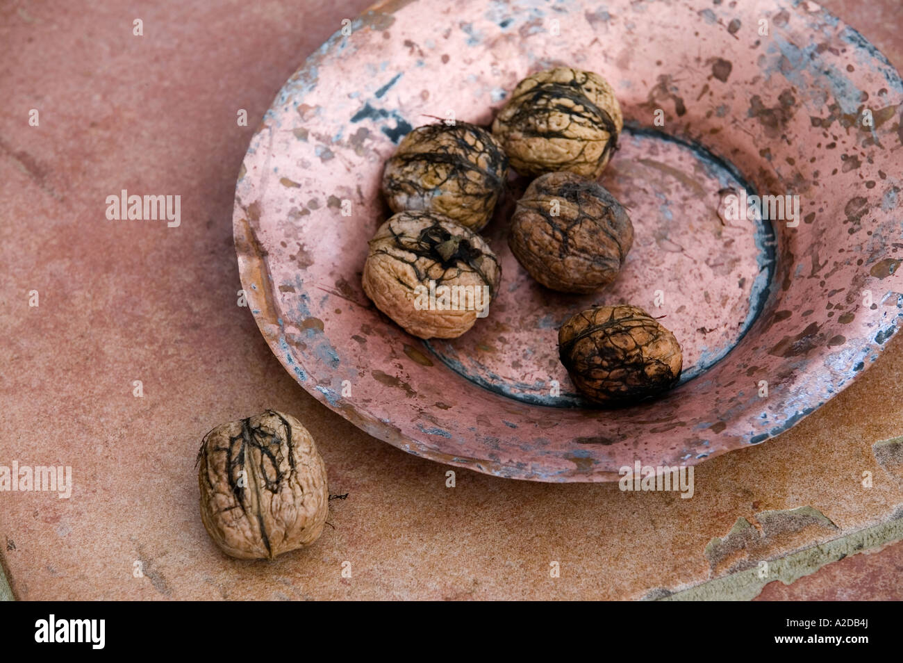 green walnuts in a copper bowl Stock Photo