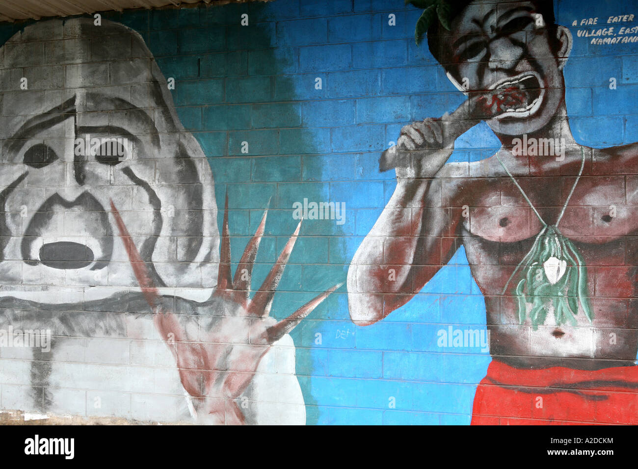Mural depicting Asaro Mudman and a fire eater, on a warehouse wall in Rabaul, East New Britain, Papua New Guinea Stock Photo