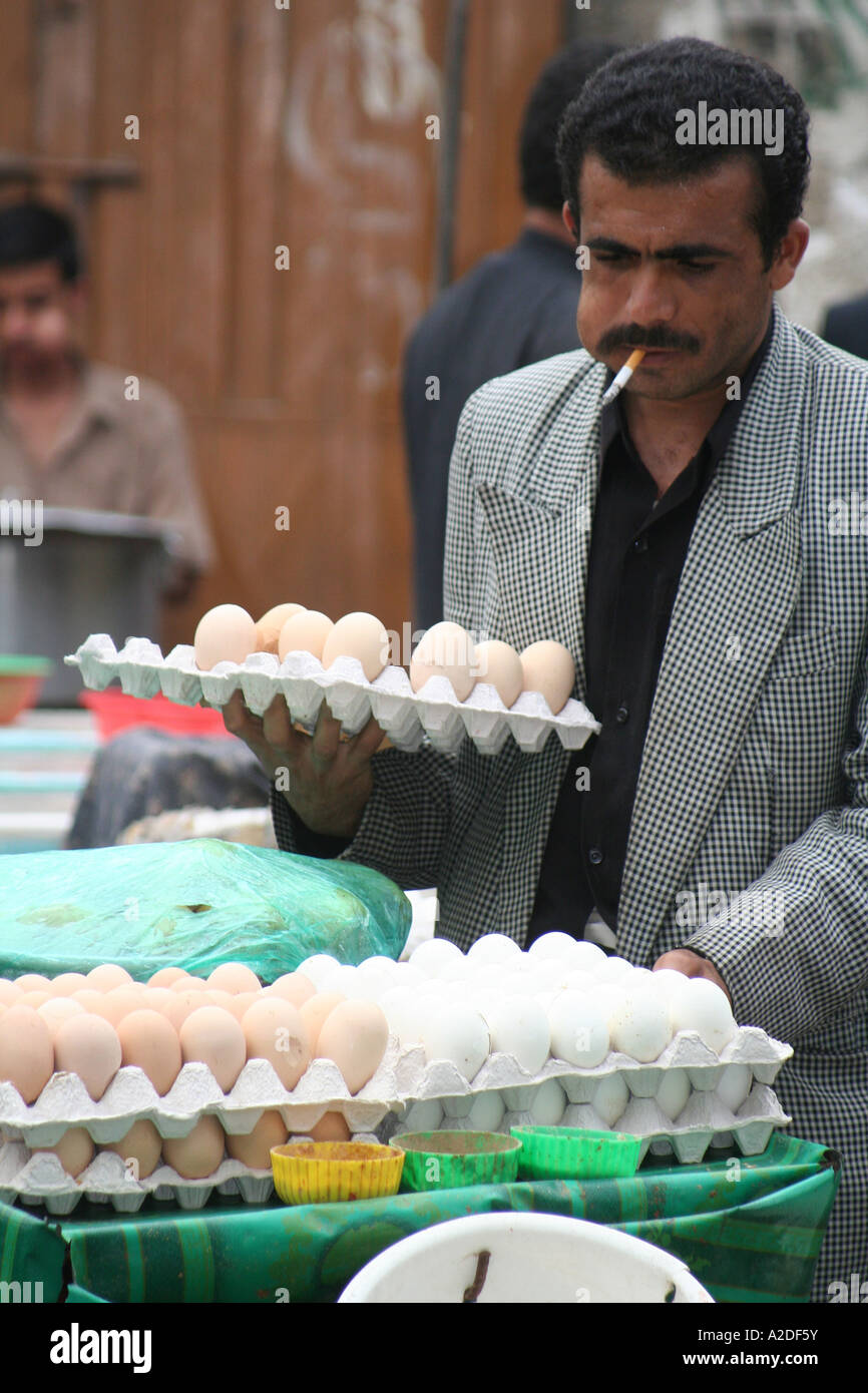 Man Selling eggs smoking chewing quat Yemen Stock Photo