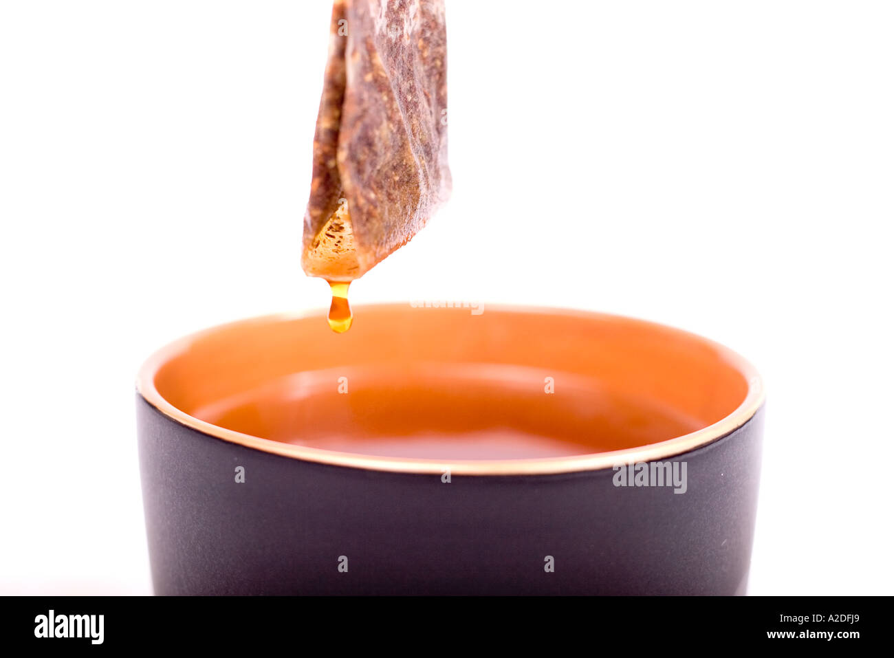 Pulling tea bag out of mug Stock Photo - Alamy
