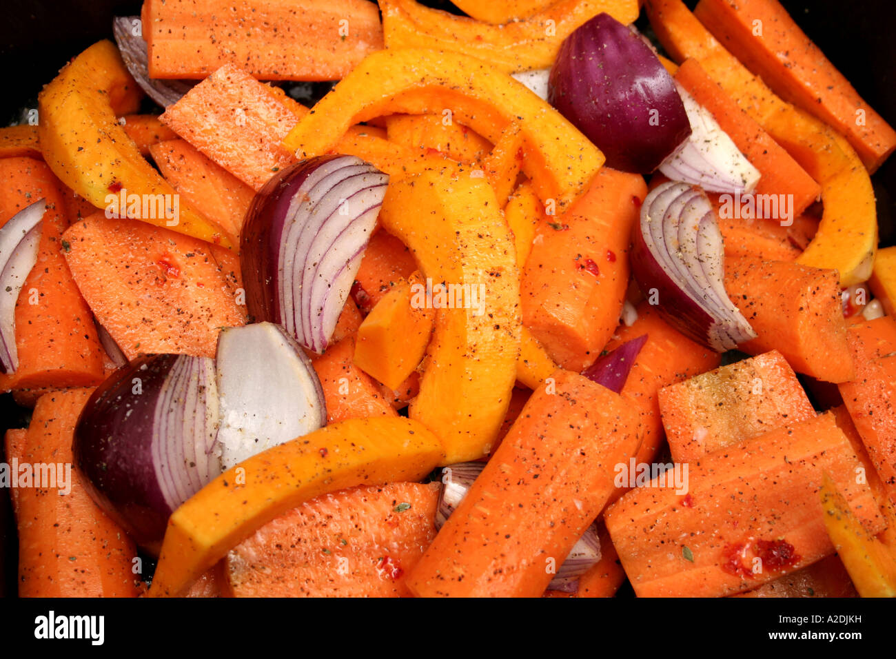 Butternut quash garlic carrots and onions prepared for roasting. Stock Photo