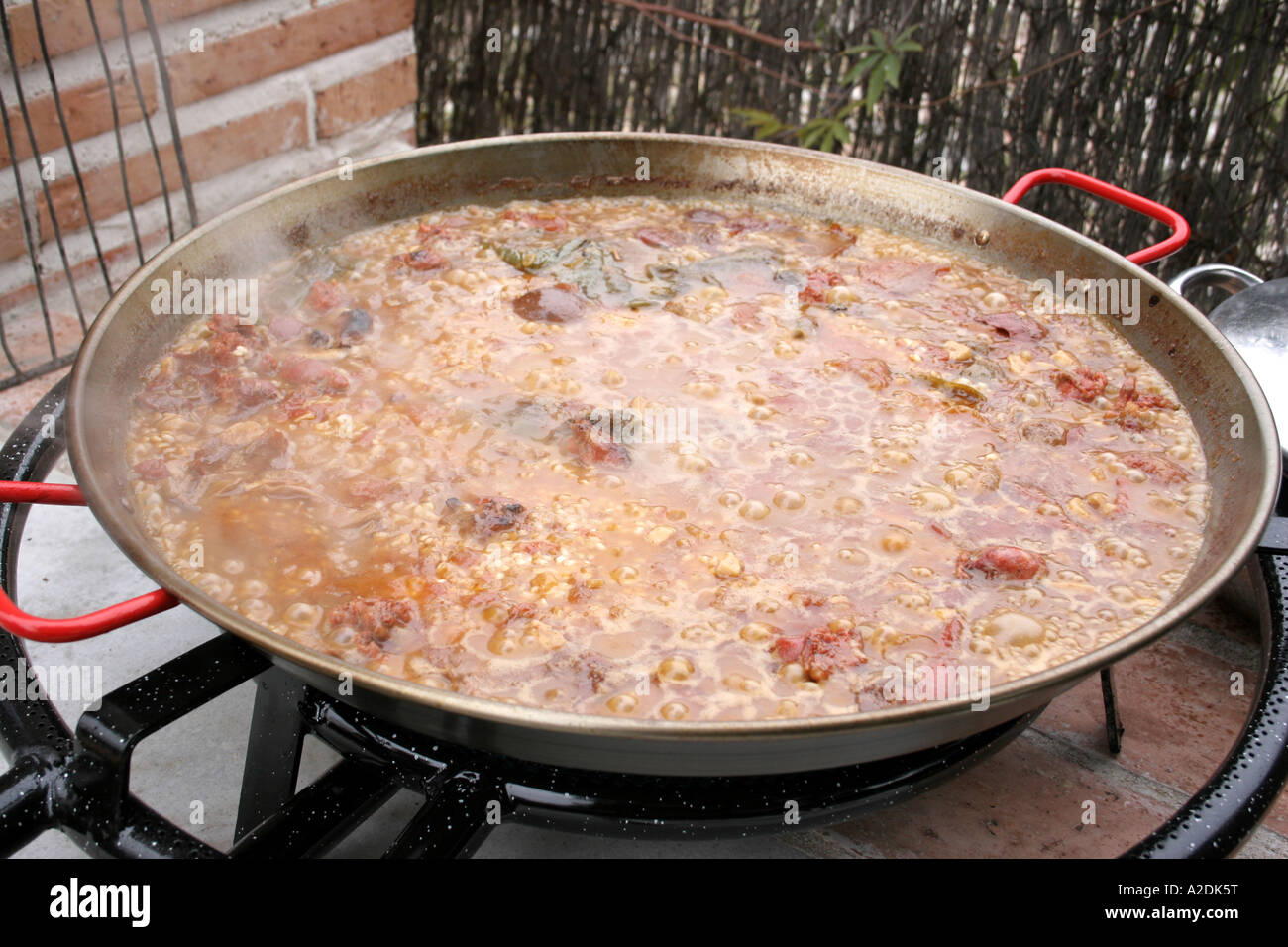 Large skillet of Paella being cooked outdoors Stock Photo - Alamy