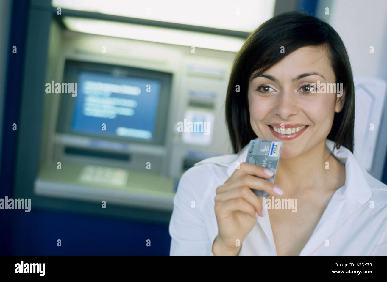 1206797 indoor outdoor bank cashpoint hold credit card woman young ...