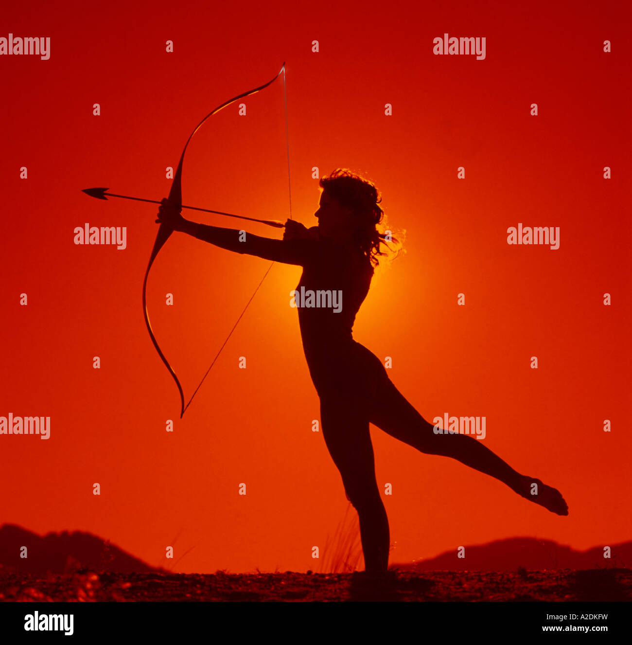young girl posing in a ballet type pose while holding a boy and arrow A2DKFW