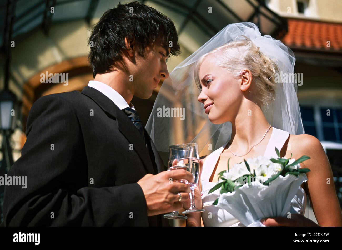 1207918 outdoor day summer church stairs couple marriage wedding newlyweds man woman young 25 30 blonde dark haired dress wed Stock Photo