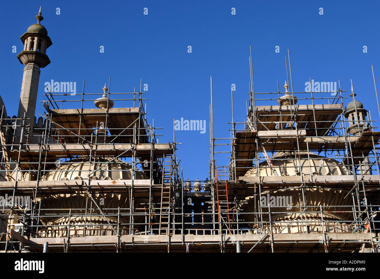 The domes of the Prince Regents Palace The Royal Pavilion Brighton East Sussex are covered in scaffolding for stonework repairs Stock Photo