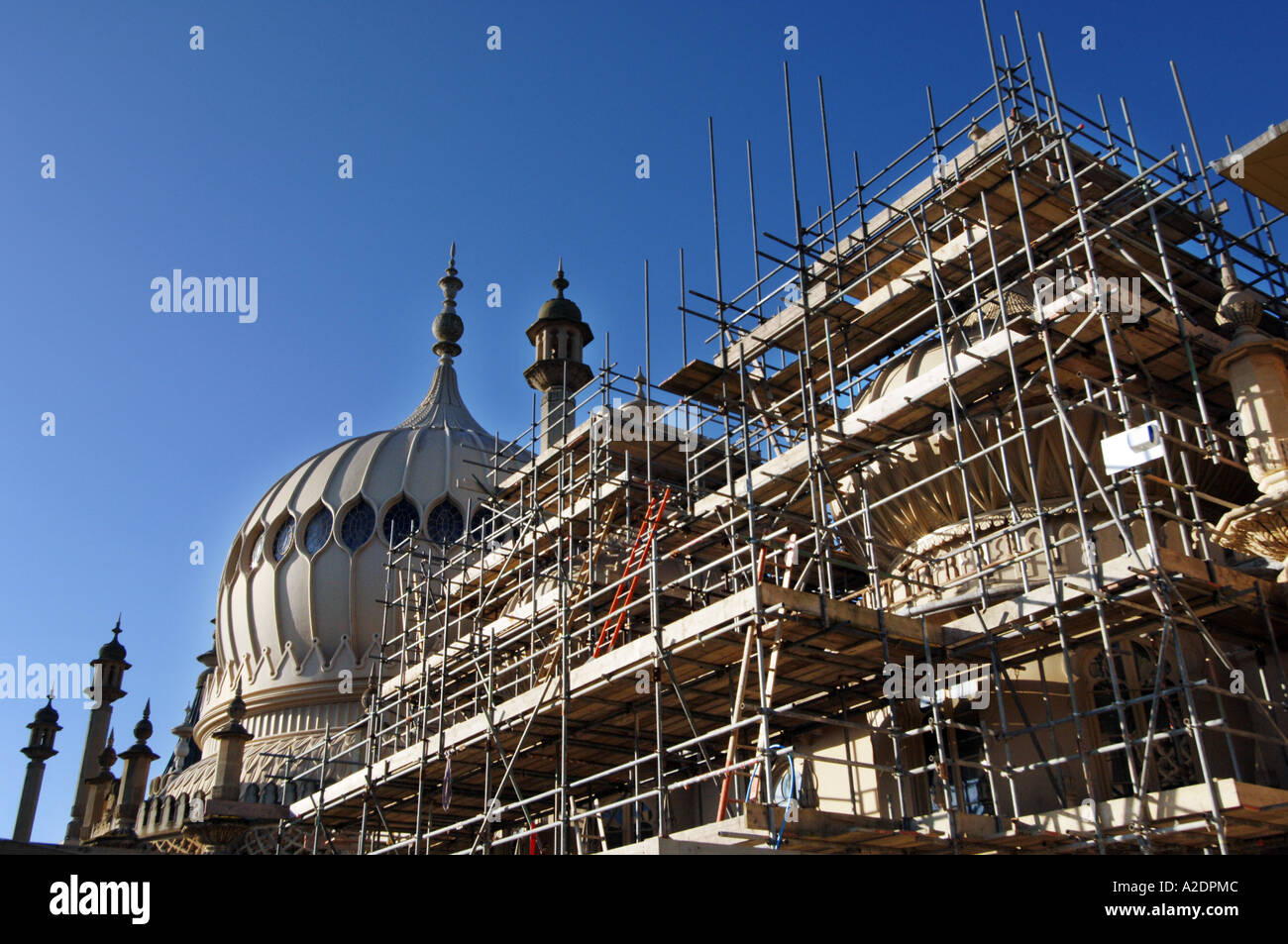 The domes of the Prince Regents Palace The Royal Pavilion Brighton East Sussex are covered in scaffolding for stonework repairs Stock Photo