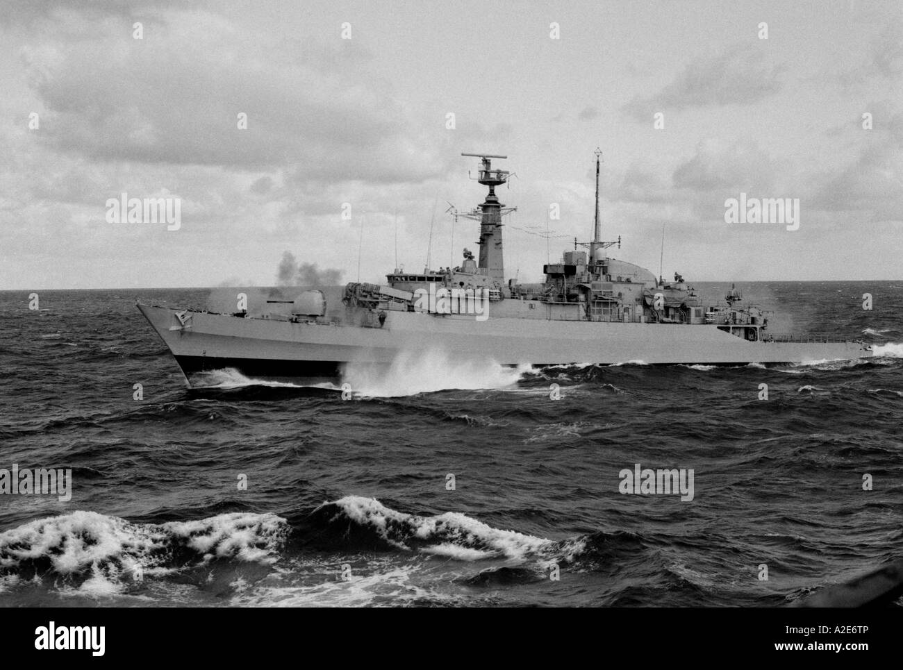 Type 21 HMS Ardent fires its Mk8 gun alongside SS Canberra during the Falklands Conflict in 1982 Stock Photo