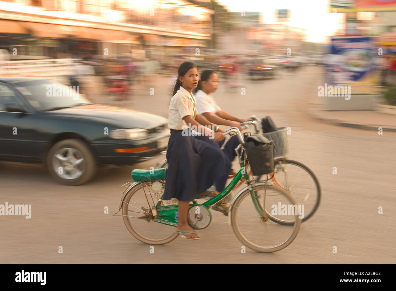 Asia, Cambodia, Siem Reap, girls on bikes in town. Stock Photo