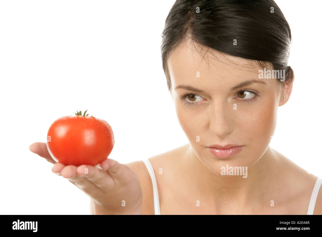 Young woman holding tomato Stock Photo - Alamy