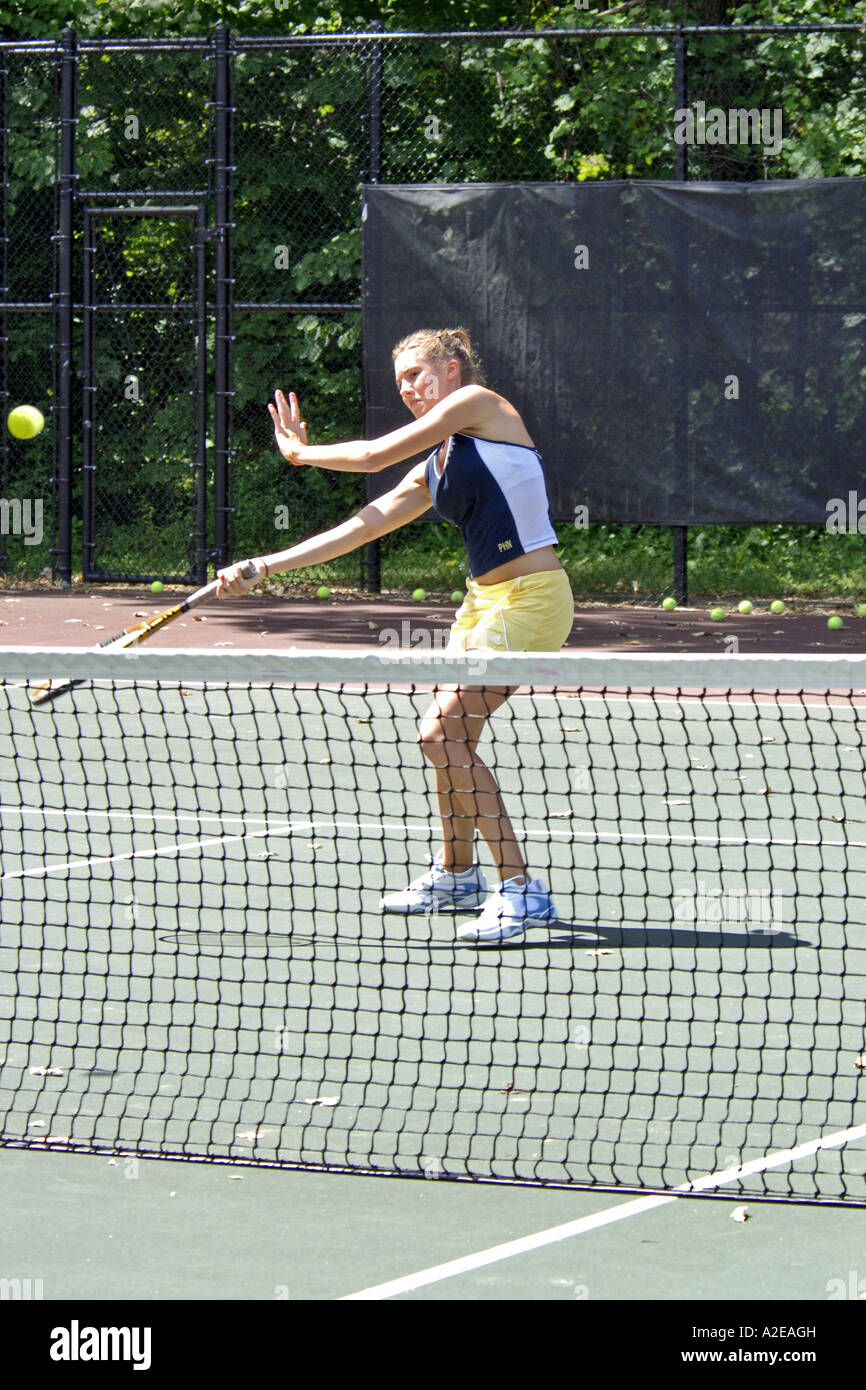 Teenage female playing at a High School tennis game in Michigan Stock