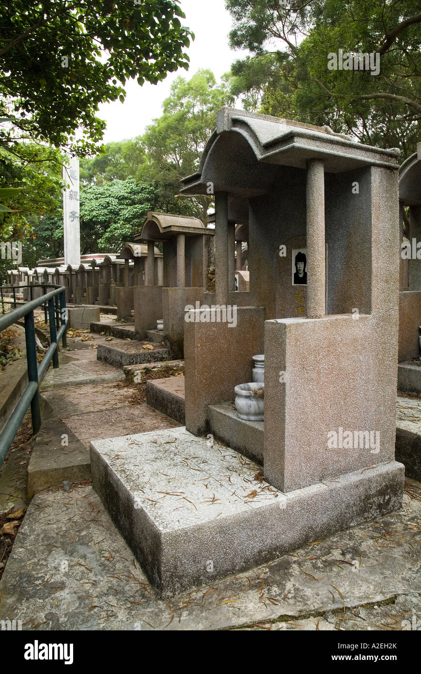 dh  CHEUNG CHAU HONG KONG Chinese graveyard rows of gravestones in woodland cemetery Stock Photo