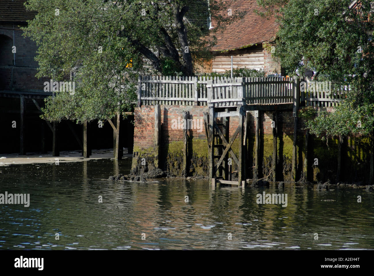 Small wooden jetty attached to the back of a house on the Beaulieu River Beaulieu Hampshire England UK 08 September 2006 Stock Photo