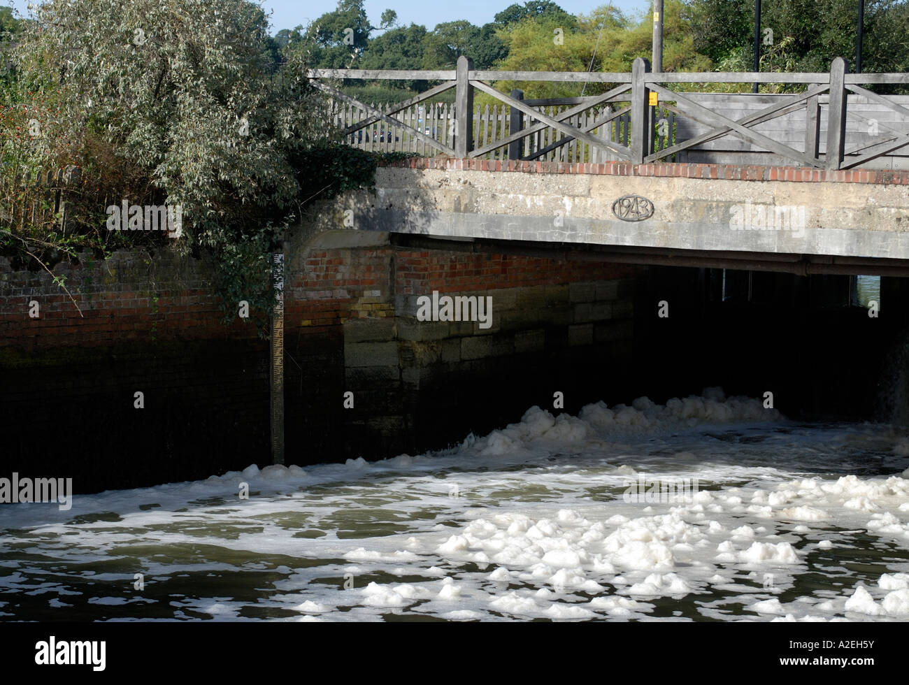 Foam on the Beaulieu River flows under the bridge at Beaulieu Stock Photo