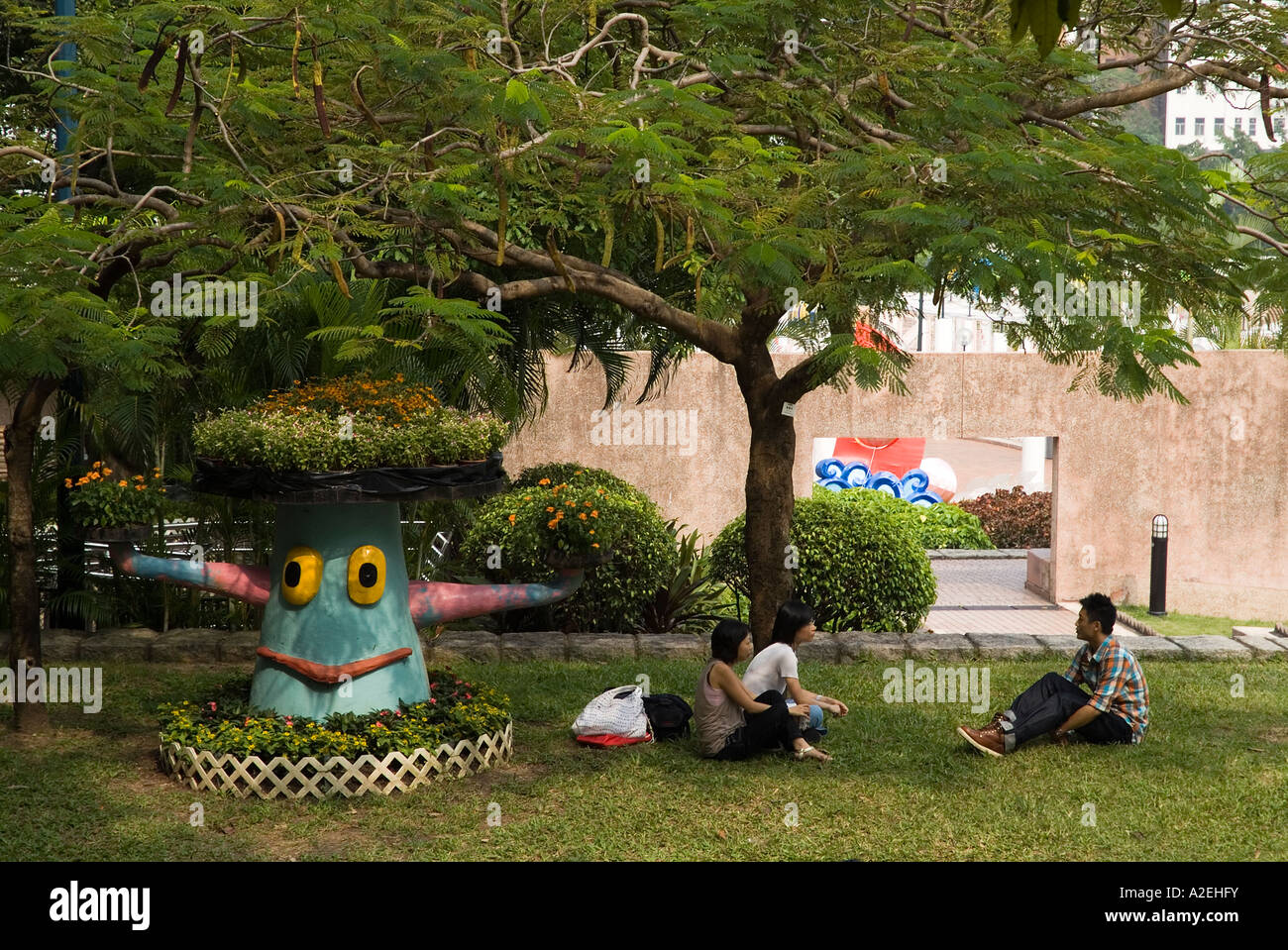 dh Kowloon Park TSIM SHA TSUI HONG KONG People relaxing sitting on grass in park Stock Photo