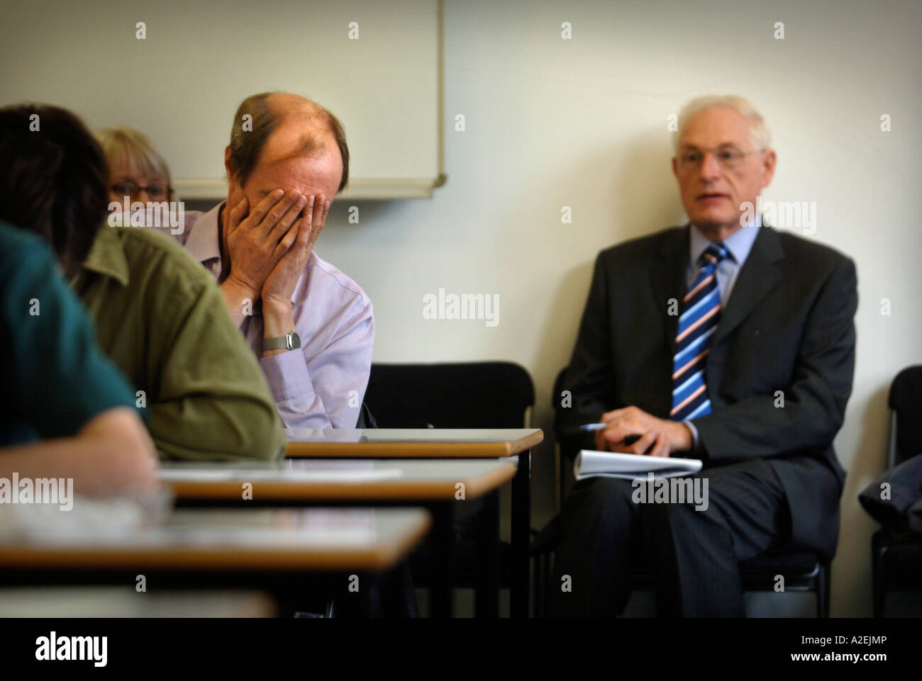 A CONTESTANT REALISES HE HAS MADE AN ERROR AT THE TIMES NATIONAL CROSSWORD COMPETITION CUP FINAL DURING THE CHAMPIONSHIPS Stock Photo