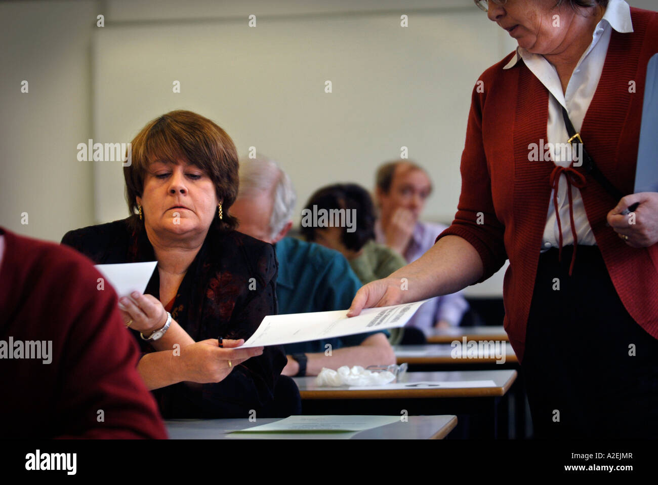 HELEN OUGHAM HANDS IN HER WINNING ENTRY AT THE TIMES NATIONAL CROSSWORD COMPETITION CUP FINAL DURING THE CHAMPIONSHIPS Stock Photo