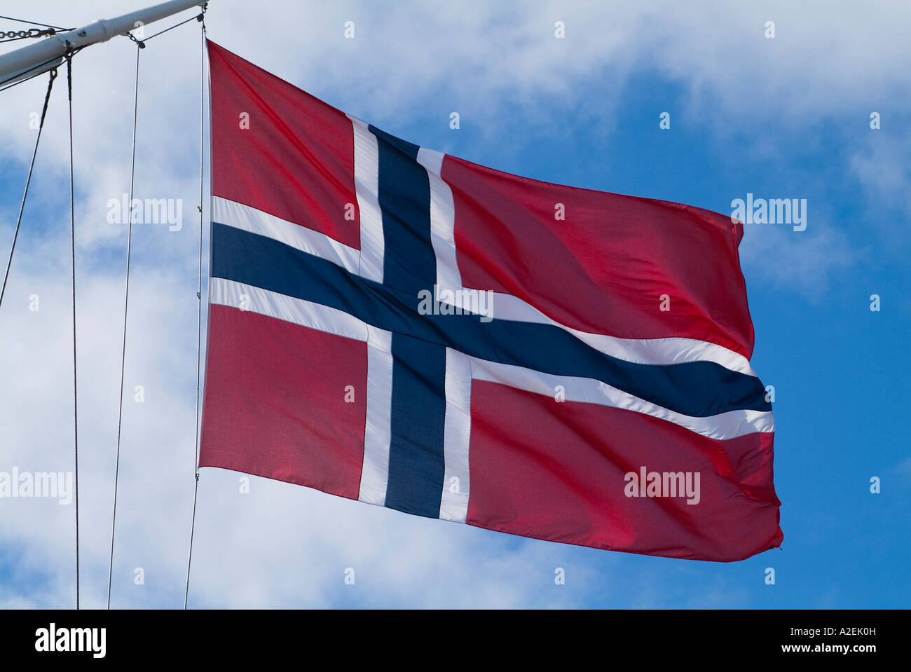 dh Norwegian flag FLAG NORWAY Red background with white and blue cross ensign on board sailing ship fly nation colours ships flags Stock Photo