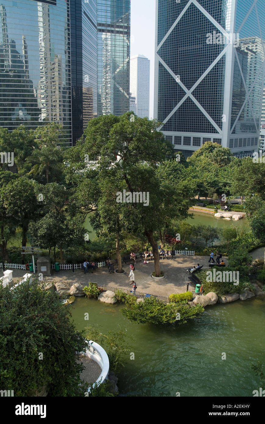dh City parkland gardens CENTRAL PARK HONG KONG ASIA Lotus pool tree people relaxing multi storey buildings garden Stock Photo