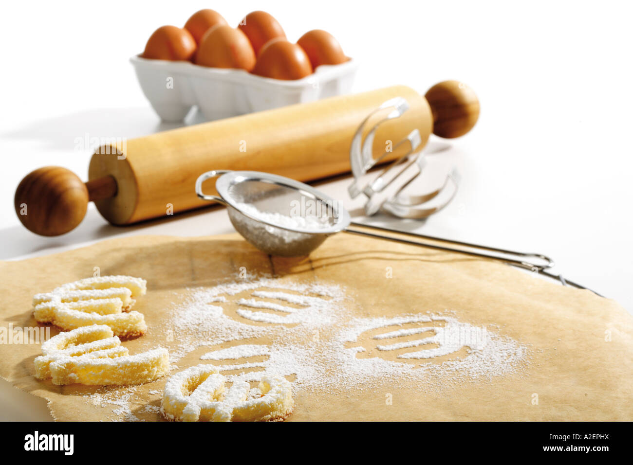 Cookies formed as euro signes on baking paper Stock Photo
