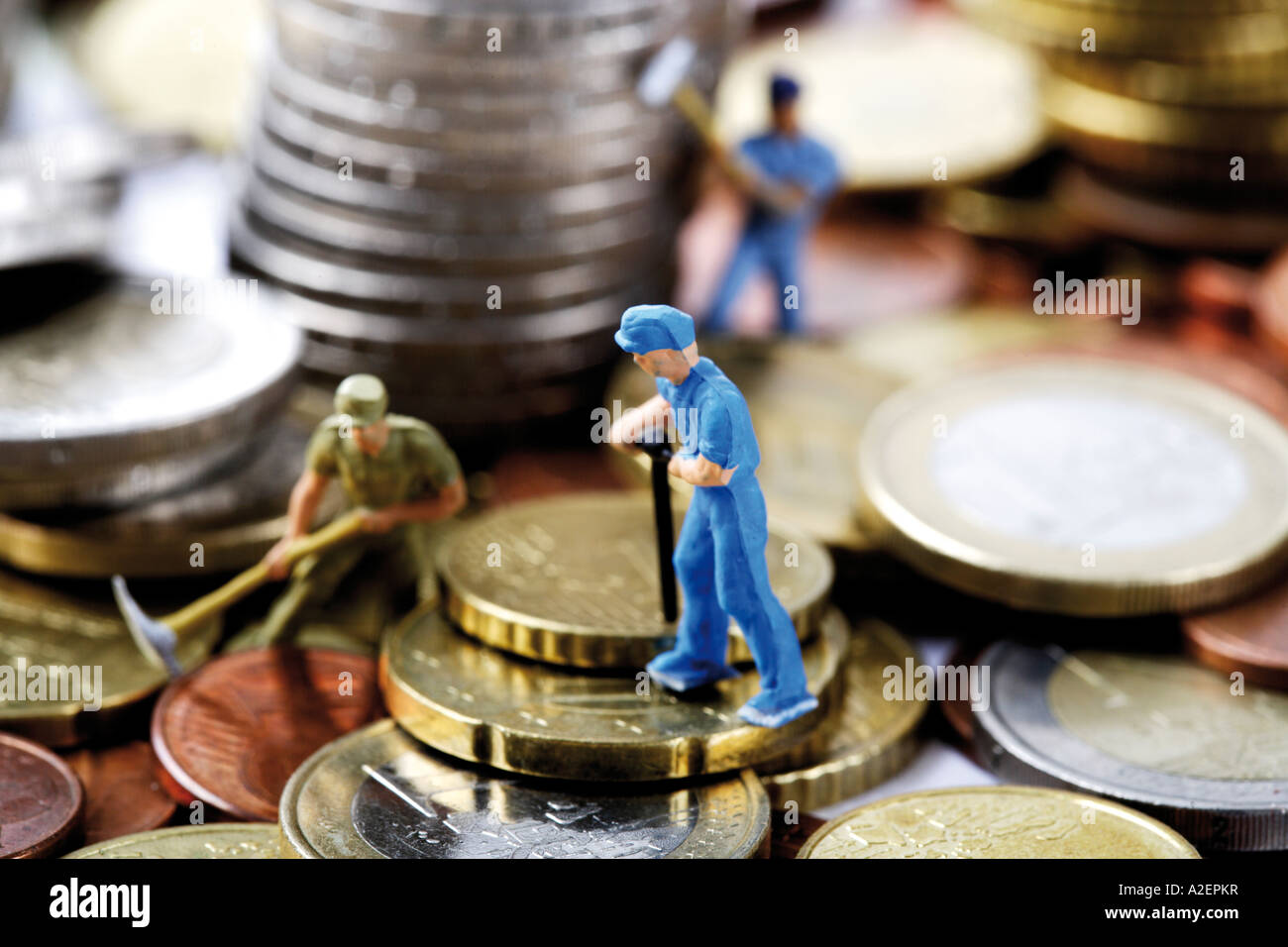 Figurines digging money Stock Photo