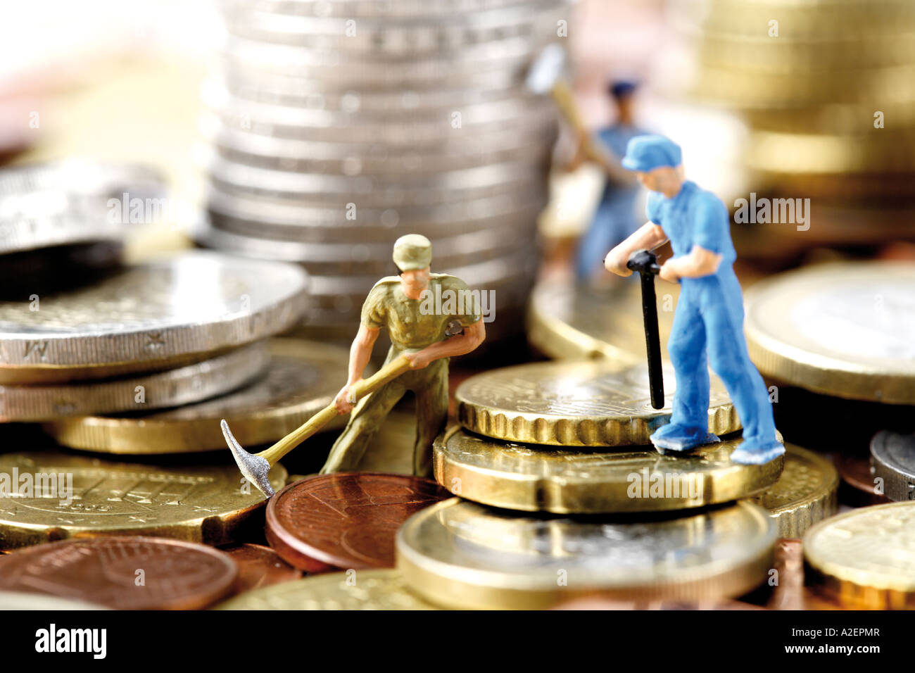 Figurines digging money, close-up Stock Photo