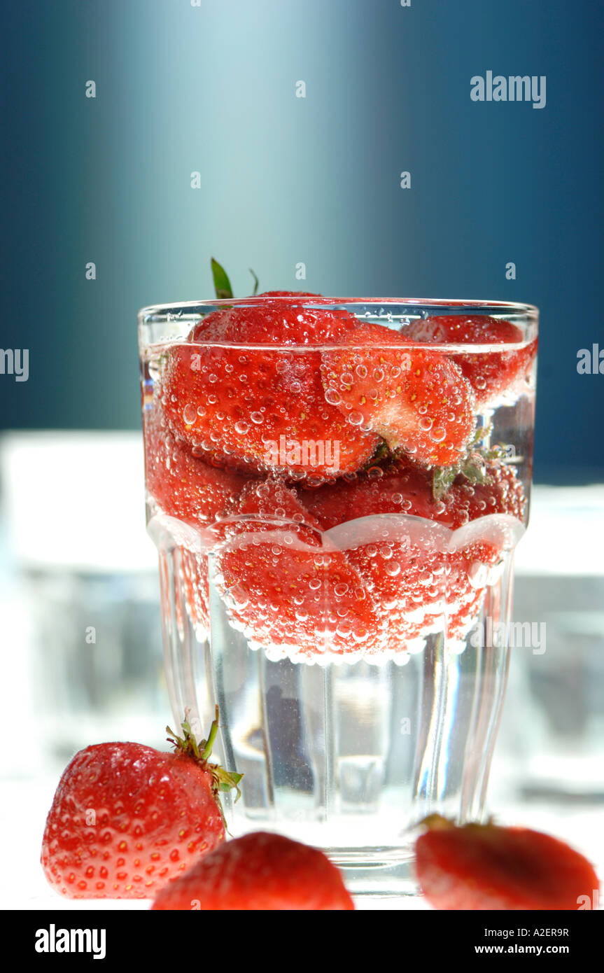 Strawberries in glass of water Stock Photo - Alamy