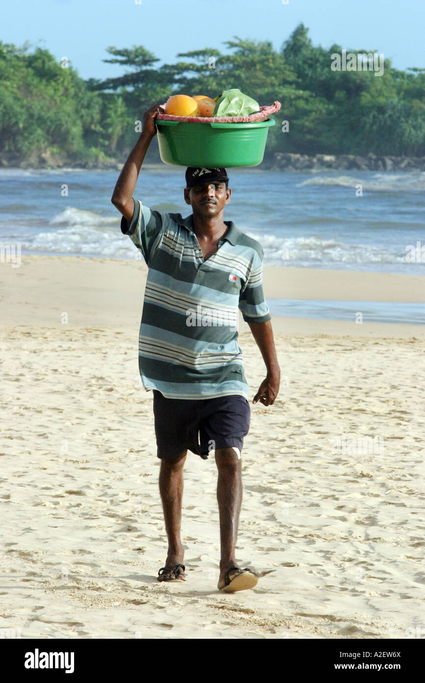 Sri Lanka beach vendor -  Fruit seller carrying goods on his head, Bentota, Sri Lanka Asia Stock Photo