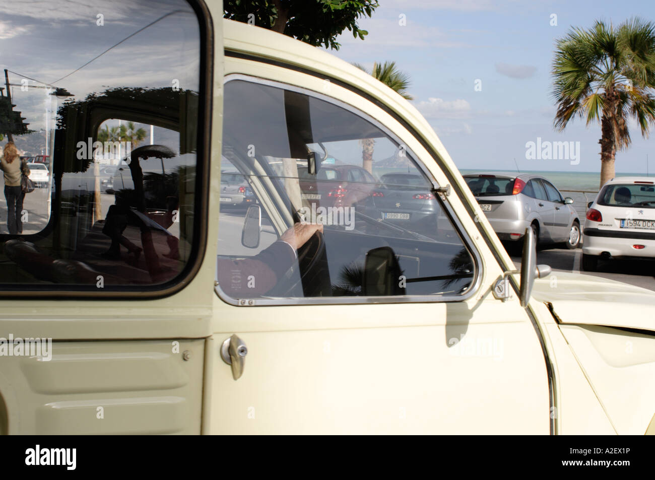 Man driving Citroen 2CV van on seafront in southern Spain Stock Photo